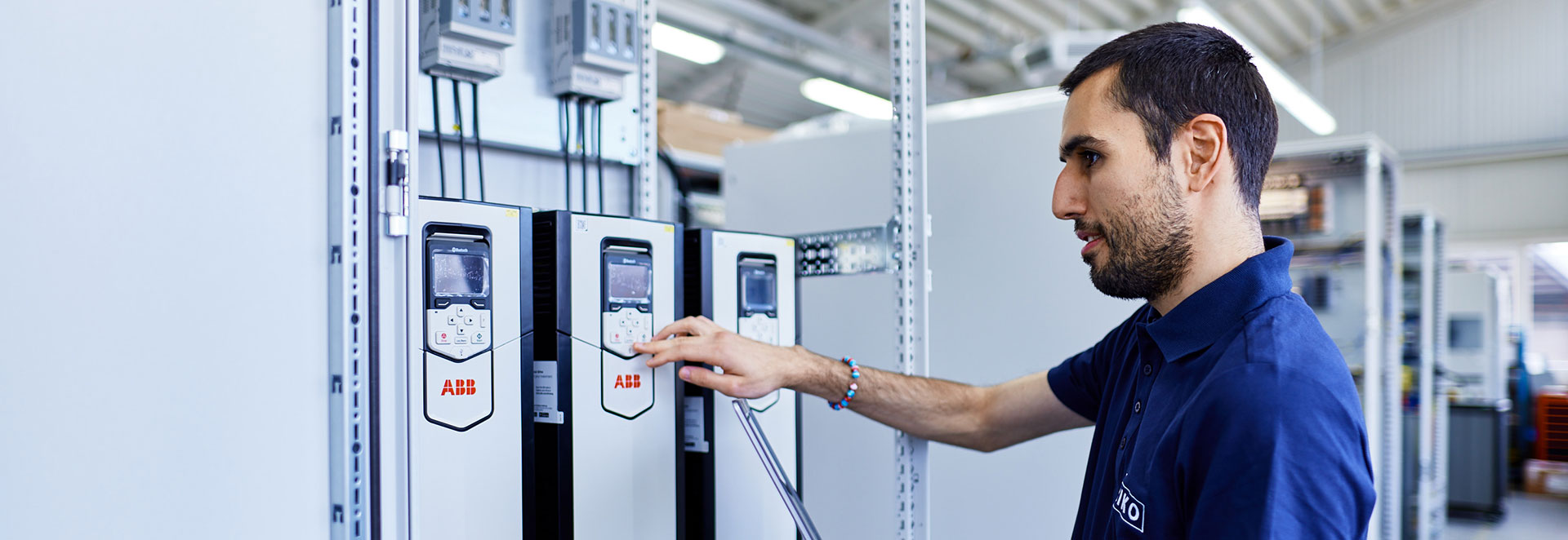 Two engineers conferring at a control cabinet